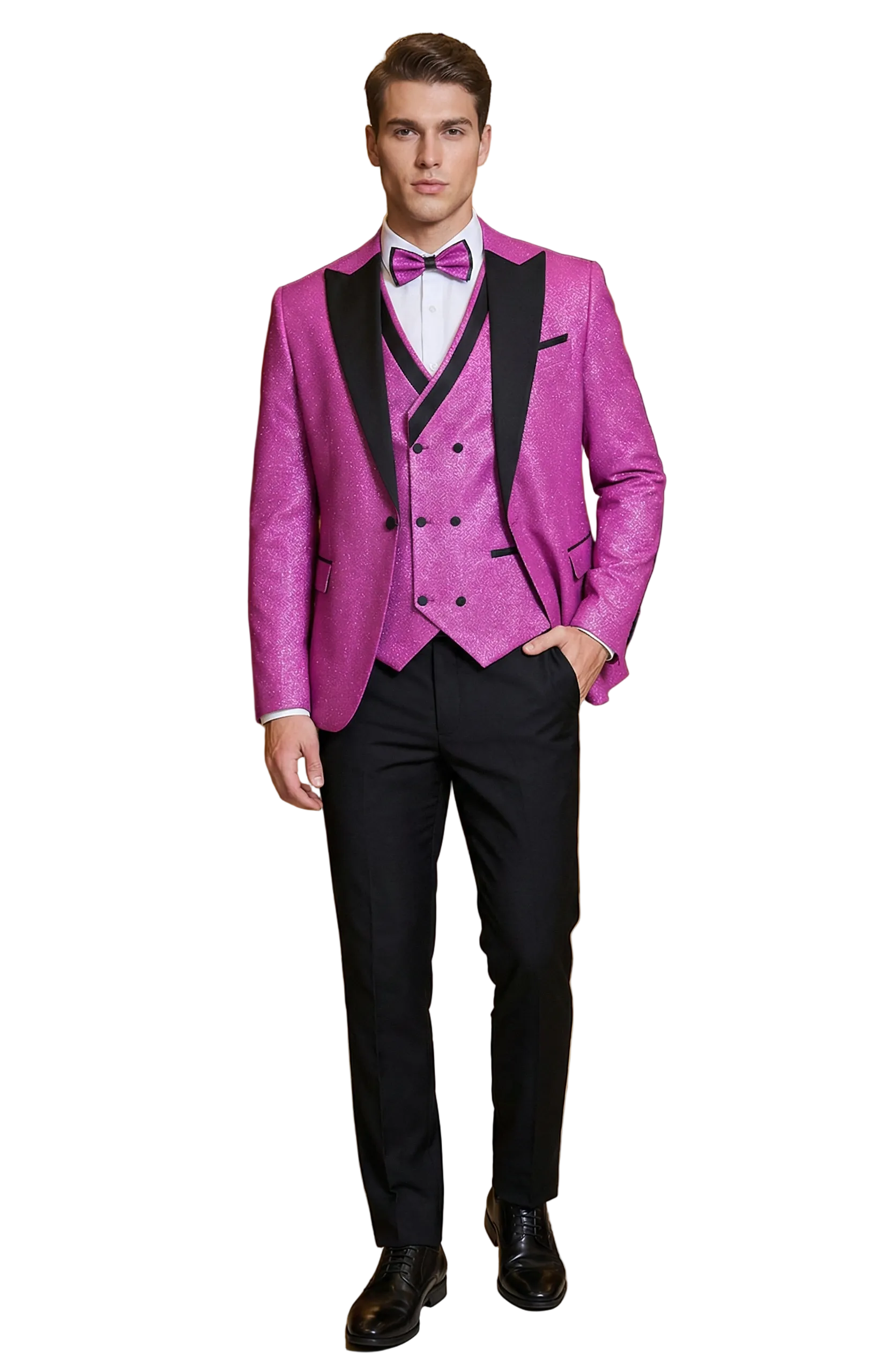 Man in a pink suit with black lapels and pants standing in an elegant interior setting.