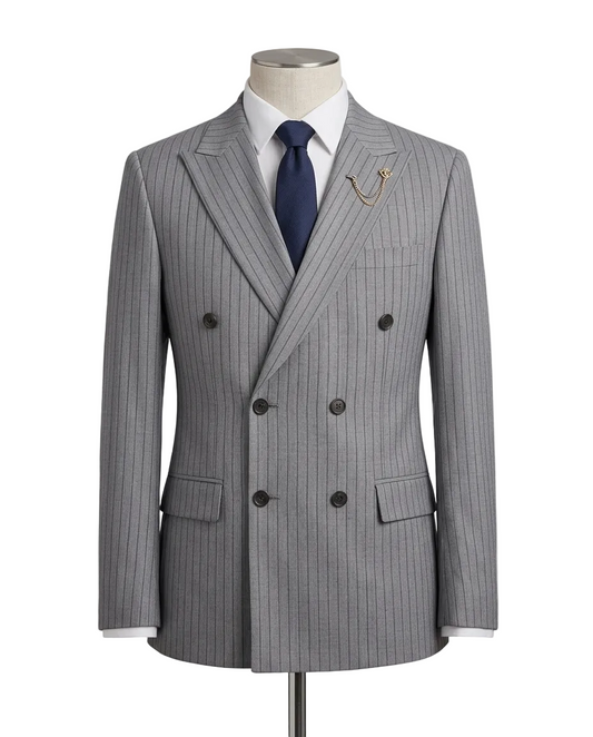 A gray double-breasted pinstripe suit jacket displayed on a mannequin torso, styled with a white dress shirt, navy blue tie, and a gold pocket watch chain.