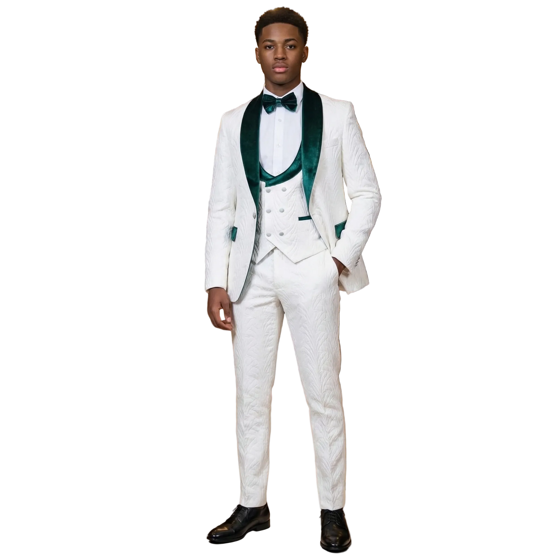 Man in a white suit with green accents standing in a luxurious room with a chandelier.