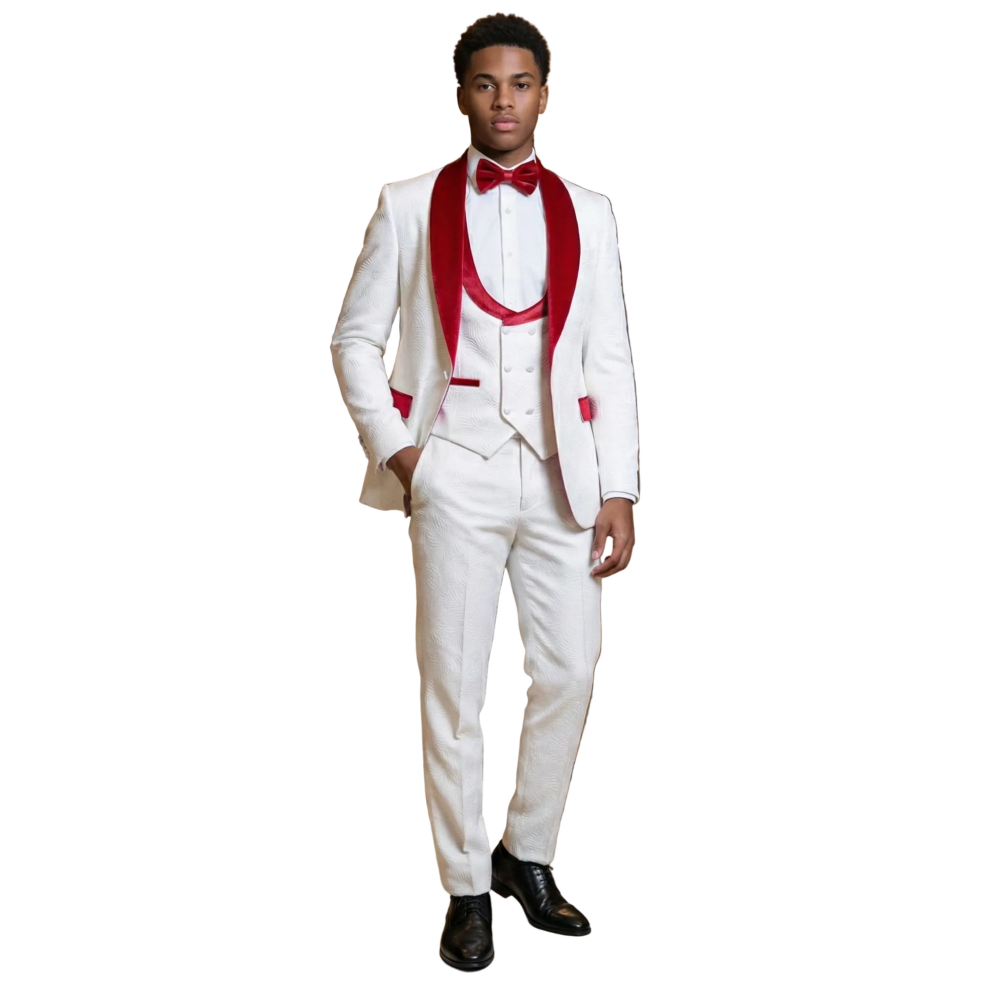 Man in a white suit with red vest and bow tie standing in an elegant interior setting.